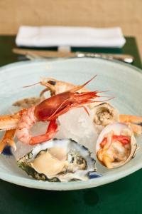 a plate of food with seafood on a table at CALEA Boutique Hotel in Bacoli