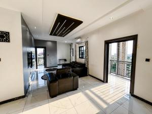 a living room with a couch and a table at Novel Apartments in Limbe