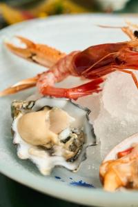a plate of food with a lobster on it at CALEA Boutique Hotel in Bacoli