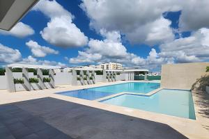 a swimming pool on the roof of a building at Apto. El Escape Punta Cana, impuestos incluidos in Punta Cana