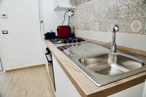 菲乌米奇诺Casa Amare Aeroporto Fiumicino的带水槽和炉灶的厨房 更多65张照片