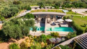 an aerial view of a house with a swimming pool at Nestor Luxury Villas in Romanu