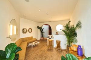a living room with a couch and some plants at CALEA Boutique Hotel in Bacoli