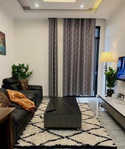 a living room with a couch and a table at CosyNook B in Kigali