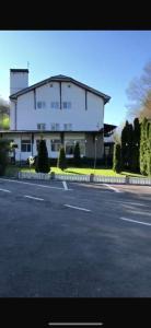 a large white building on the side of a street at Terasa Baniei in Bucovăţ