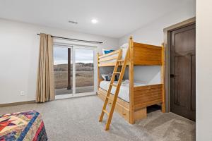 a bedroom with two bunk beds and a window at Pleasant Valley Getaway in Sturgis