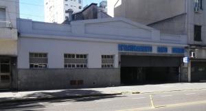 a white building with a garage on the side of a street at BuenosAiresFlour in Buenos Aires