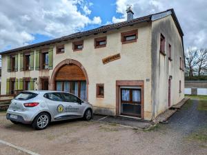 a car parked in a parking lot in front of a building at Gîte rénové avec parking à proximité de Saint-Dié-des-Vosges - FR-1-589-675 in Saint-Michel-sur-Meurthe