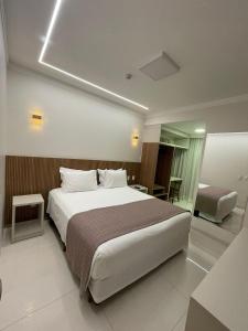 Cama ou camas em um quarto em Hotel Jardim