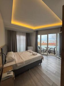 a bedroom with a large bed and a balcony at Büyükada Marine House Hotel in Istanbul