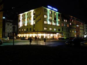 a building with a sign on top of it at night at Hotel Central Hauptbahnhof in Heidelberg