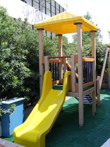 a playground with a yellow slide and a gazebo at Hotel Elida in Platanes