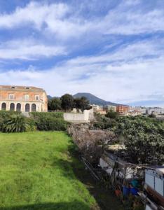 a view of a building and a field of grass at Dimora Borbonica in Ercolano