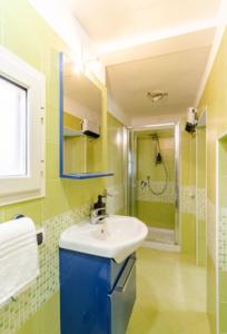 a bathroom with a sink and a shower at Dimora Borbonica in Ercolano +19 photos