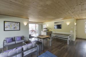 a living room with a couch and a table at Alplodge in Interlaken