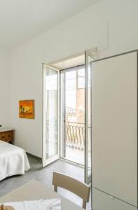 a bedroom with a bed and a sliding glass door at Dimora Borbonica in Ercolano