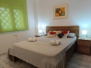 a bedroom with a bed with two pillows on it at Charming apartment in Cádiz, 63 m² with welcoming terrace in Cádiz