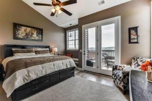 a bedroom with a bed and a ceiling fan at Penthouse Lakeview Haven in Branson +22 photos