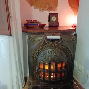 a fireplace with a clock on top of it at Casa Blava in Castelló d'Empúries