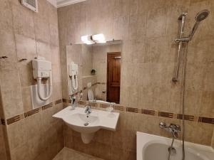 a bathroom with a sink and a shower at St Ivan Rilski Private Apartment - 4 stars SPA - Slopes View in Bansko +17 photos