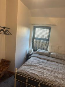 a bedroom with a bed and a window at Morecambe Bay Cottage in Morecambe