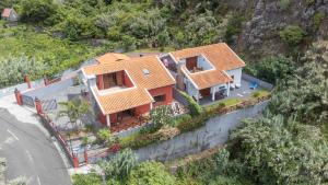 an aerial view of a house on a hill at Casa del Mar I by GALMI in Arco de São Jorge