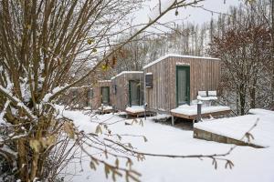 a row of camping huts in the snow at Green Tiny Village Harz - Sleep Space 32 in Osterode