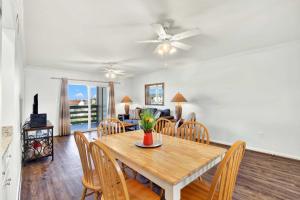 a dining room with a wooden table and chairs at Lighthouse Point Rental 2C in Tybee Island