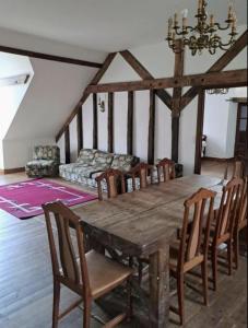 a dining room with a wooden table and chairs at Appartement des écuries in Château-Chervix