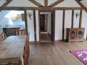 a kitchen and dining room with a wooden table at Appartement des écuries in Château-Chervix