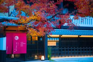 a tree with red leaves in front of a building at Kyoto Takasegawa Bettei - Vacation STAY 69818v in Kyoto