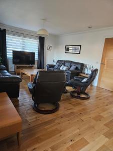 a living room with a couch and a table at Beolary in Oban