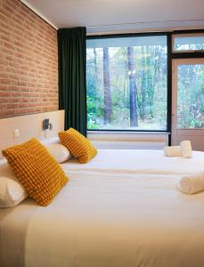 a bedroom with two beds with a large window at Buitengoed Fredeshiem in De Bult +47 photos