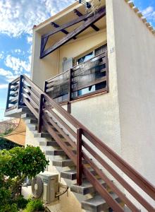 a set of stairs leading up to a building at Studio Cosy à 200m de la plage Wi-Fi in Le Barcarès