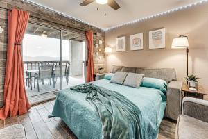 a bedroom with a bed and a large window at 1 Mi to Silver Dollar City! Lake-View Family Haven in Branson +33 photos