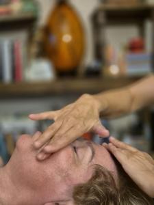 a man getting a hair cut with his hands at Bonaluti Adults - Azyl Dla Dorosłych in Mirsk