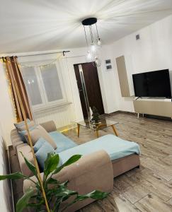 a living room with a couch and a table at Sielskie Apartamenty in Sandomierz