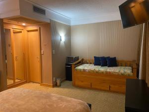 a hotel room with a bed and a television at Flat Hotel em Guarulhos in Guarulhos +13 photos