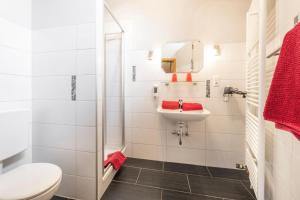 a white bathroom with a sink and a toilet at Pension ohne Frühstück in Gößweinstein