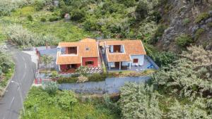 an aerial view of a house on a mountain at Casa del Mar II by GALMI in Arco de São Jorge