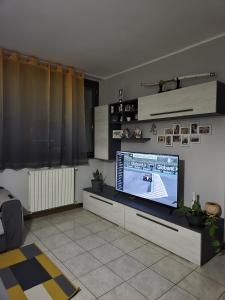 a living room with a large flat screen tv at Casa Margherita in Tribiano