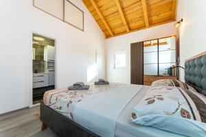 a bedroom with a large bed in a room at MY DALMATIA - Sea view holiday home Fortica in Rtina