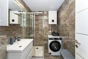 a bathroom with a sink and a washing machine at MY DALMATIA - Sea view holiday home Fortica in Rtina +37 photos