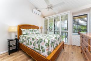 a bedroom with a bed and a window at Beautiful Kuilima East Estates Townhome - Golf Course & Ocean Views in Kahuku +29 photos