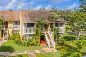 a house with a staircase in the yard at Beautiful Kuilima East Estates Townhome - Golf Course & Ocean Views in Kahuku