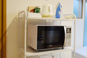 a microwave on a shelf in a room at Hostel In Kyoto Gion - Vacation STAY 13366v in Gionmachi +6 photos