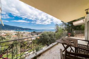 a balcony with a table and a view of the water at Villa Andrea in Skala Potamias