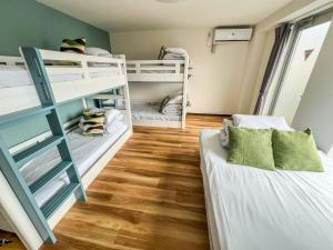 two bunk beds in a room with wooden floors at Hostel In Kyoto Gion - Vacation STAY 13382v in Gionmachi