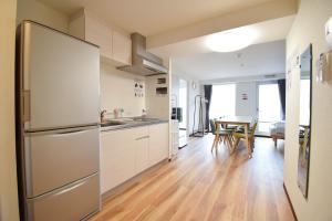 a kitchen with a refrigerator and a table at Hostel In Kyoto Gion - Vacation STAY 13382v in Gionmachi