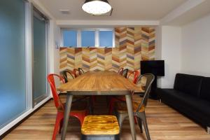 a dining room with a table and chairs and a couch at Hostel In Kyoto Gion - Vacation STAY 13400v in Gionmachi +16 photos